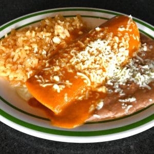 Kids #1. Enchilada served with rice and beans.